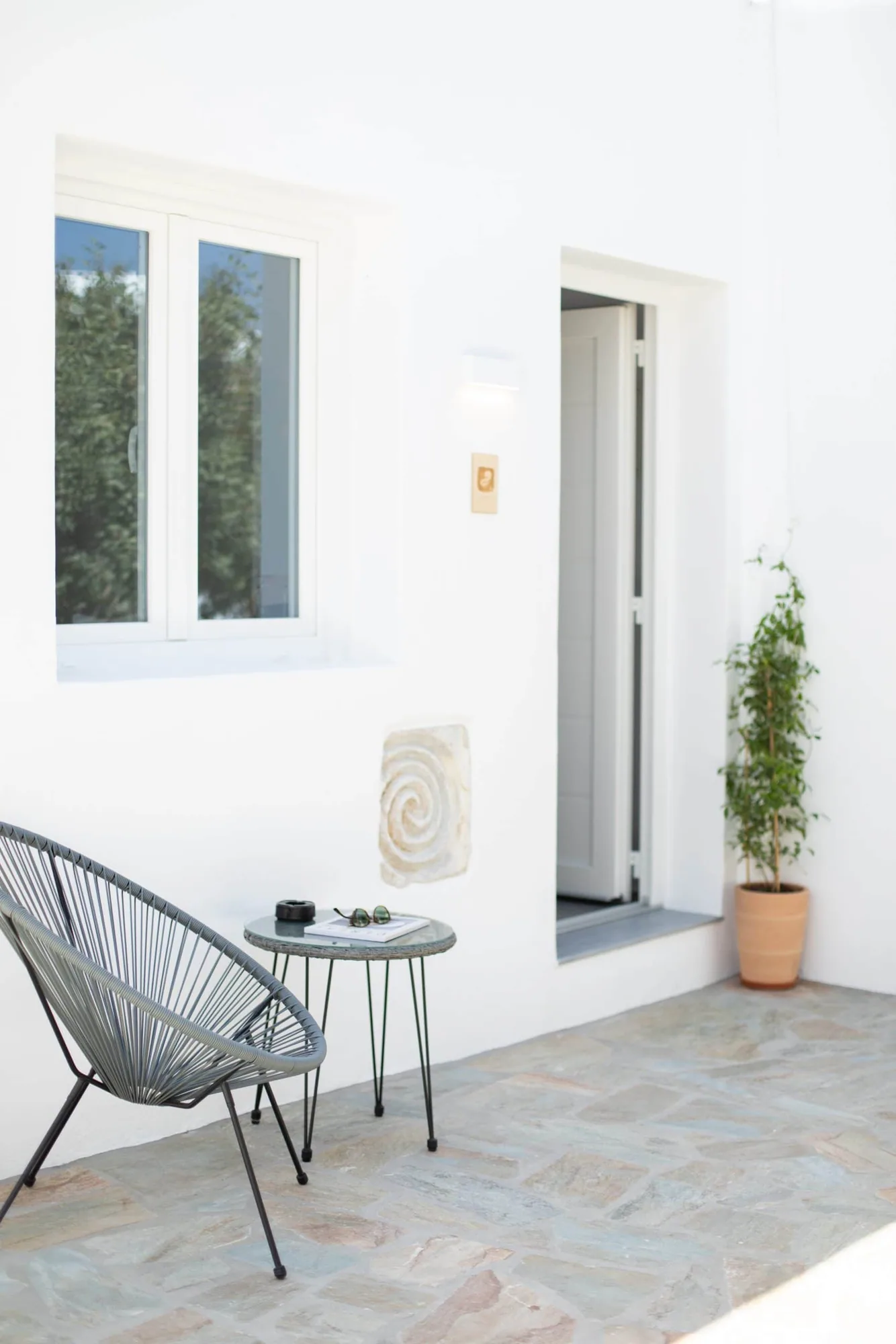 Private terrace with rope chair and table outside the Garden Suite